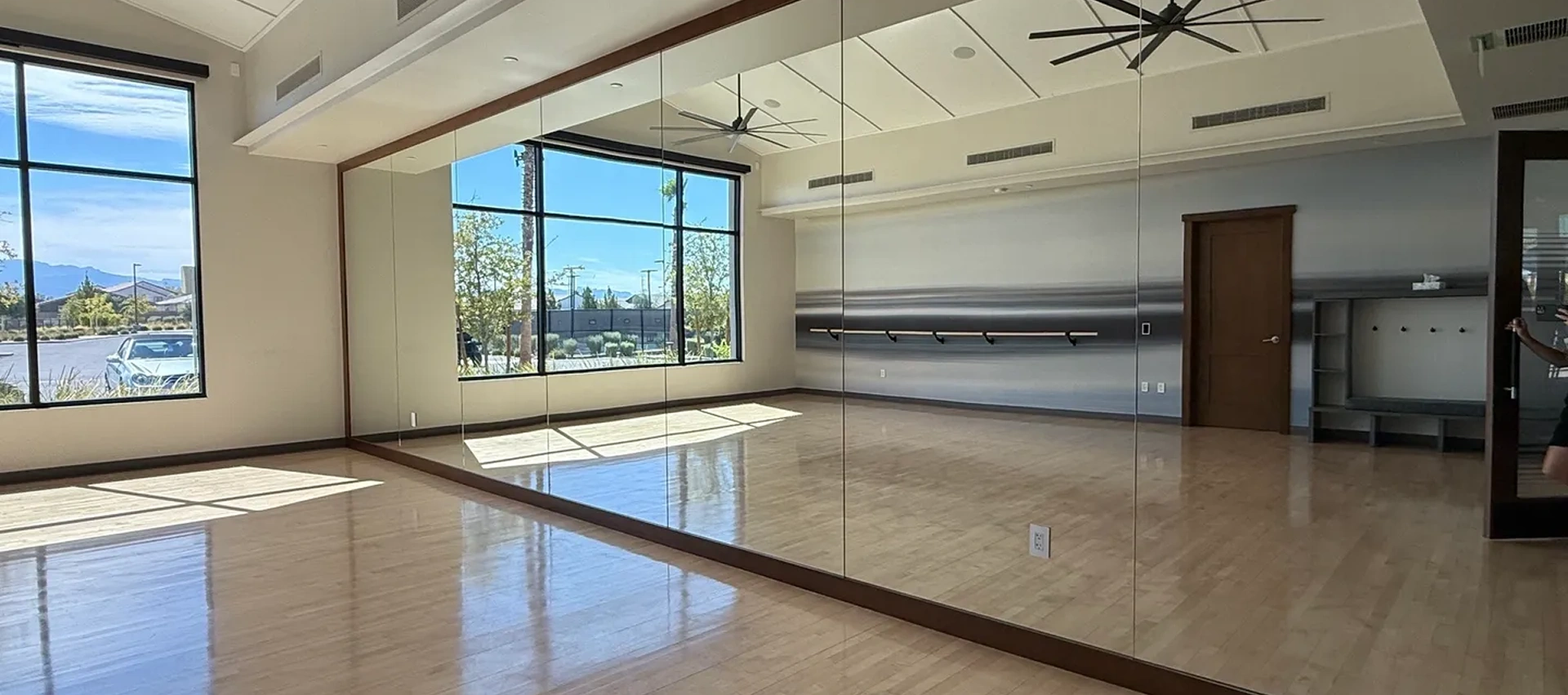 Spacious dance studio with mirrored walls.